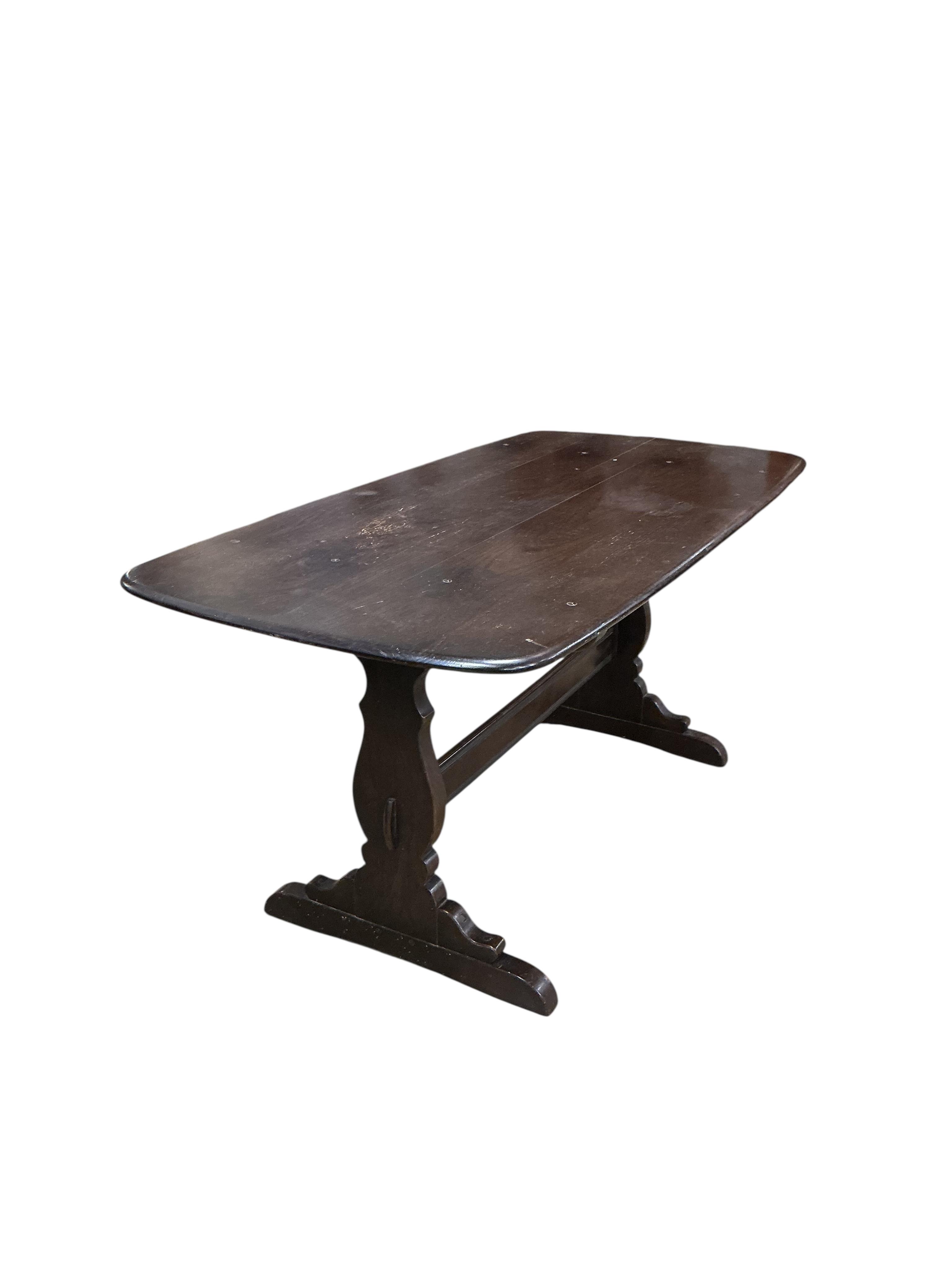 An Ercol dark elm rectangular dining table, width 150cm, depth 77cm, height 72cm and four Ercol chairs